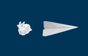 a crumpled ball of paper is turned into a paper airplane